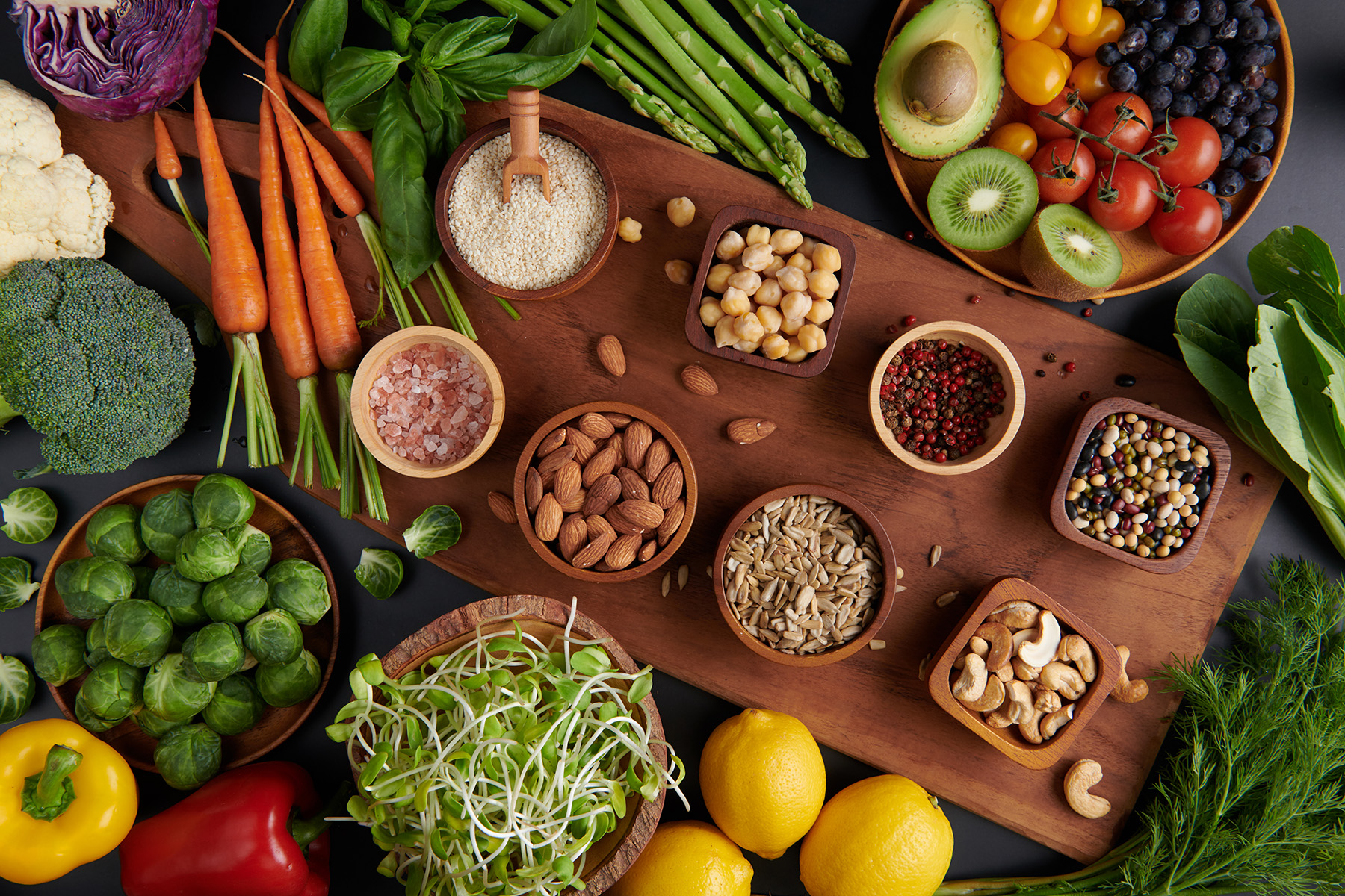 Different vegetables, seeds and fruits on table. Healthy diet.vegetarian, vegan food cooking ingredients. Flat-lay of vegetables, fruit, beans, cereals, kitchen utencil, dried flowers, top view.